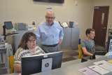 Frank Gornick visits with Amy Freitas and John Charles in the Student Center.